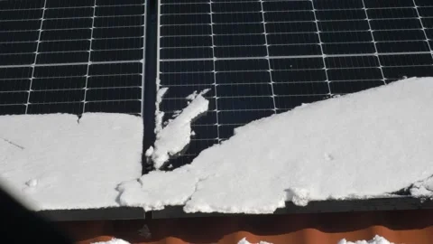 Snow Melting on PV Solar Panels Located on Private House Roof on Sunny Day Stock Footage 306231885