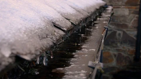 Snow Melting Off a Roof and Dripping Into a Gutter, Ireland Stock Footage