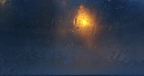 Snow melts the windshield rain on window  street lights stained glass Video stock 62820021