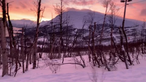 Snow mobiling over snow covered Lappland hills near Bjorkliden, Sweden, Europe Stock Footage 169808554