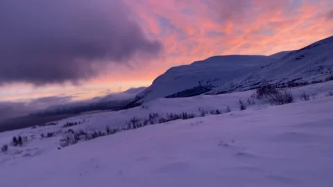 Snow mobiling over snow covered Lappland hills near Bjorkliden, Sweden, Europe Stock Footage 169808565