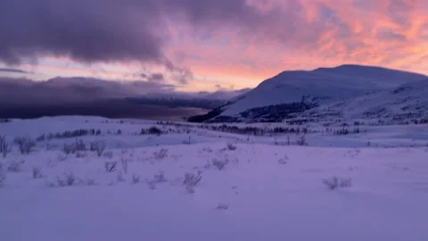 Snow mobiling over snow covered Lappland hills near Bjorkliden, Sweden, Europe Stock Footage 169808583