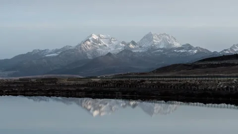 Snow Mountain Light and Shadow Play with Moving Clouds Time-lapse Stock Footage 326706070
