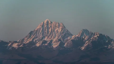 Snow Mountain Light and Shadow Play with Moving Clouds Time-lapse Stock Footage 326706075