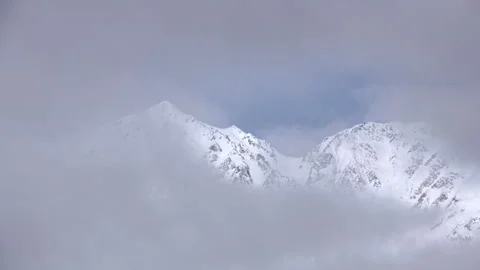 Snow mountains with clouds and mist is beautiful landscape by time-lapse Stock Footage 149921886