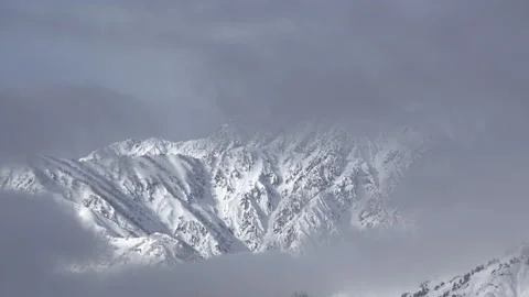 Snow mountains with clouds and mist is beautiful landscape by time-lapse Stock Footage 149966206