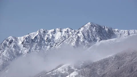 Snow mountains with clouds and mist is beautiful landscape by time-lapse Stock Footage 149976174