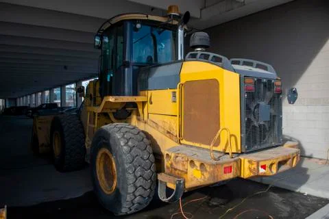 Snow Mover Wheel Loader Machine Parked in Parkade Stock Photos