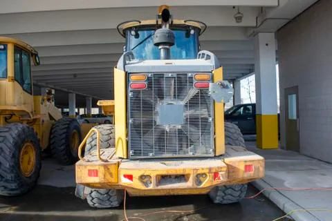 Snow Mover Wheel Loader Machine Parked in Parkade Stock Photos