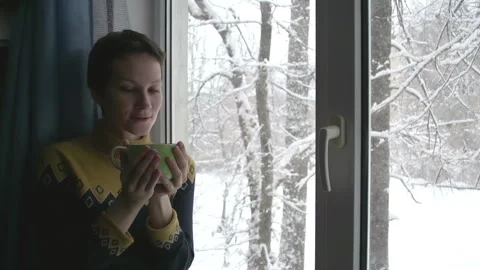 Snow Outside the Window and Hot Tea 4K TZ Stock Footage 313387932