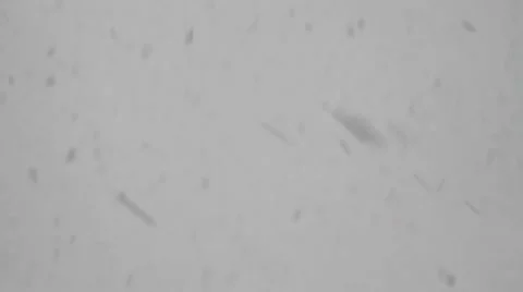 Snow particles falling down from the sky against grey background Stock Footage 39744726