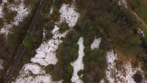 Snow-Patch Fields and Winding Road in Norwegian Countryside Stock Footage 334739102