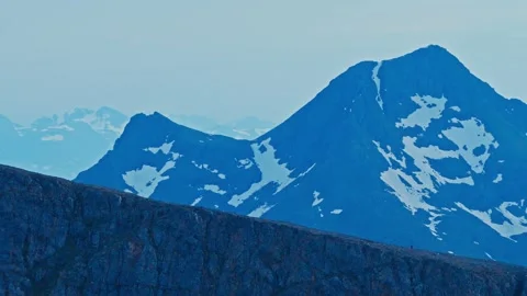Snow Patches Mark the Steep Mountain Peaks Near Middagsfjellet in Sandland Stock Footage 332150176