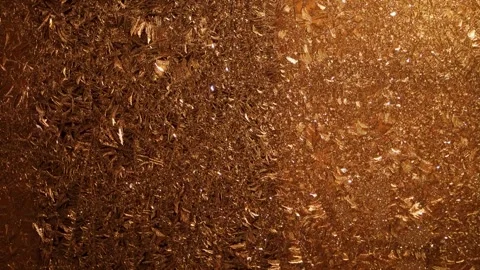 Snow pattern on the window pane. A yellow lantern is shining outside the window. Stock Footage 260824233