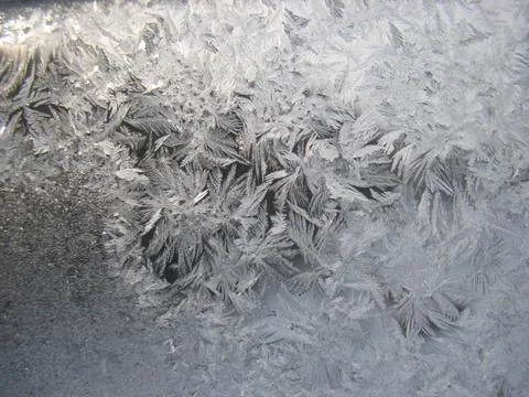 Snow pattern on winter window... Stock Photos