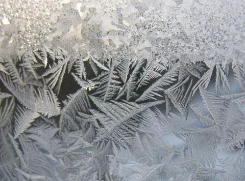 Snow pattern on winter window... Stock Photos