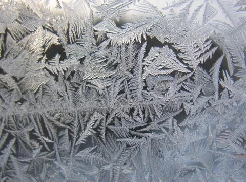 Snow pattern on winter window... Stock Photos