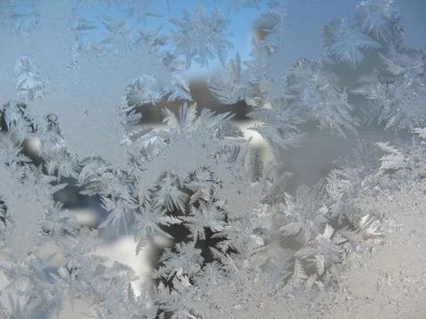 Snow pattern on winter window... Stock Photos