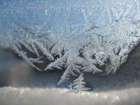 Snow pattern on winter window... Stock Photos