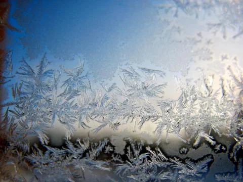 Snow pattern on winter window Stock Photos