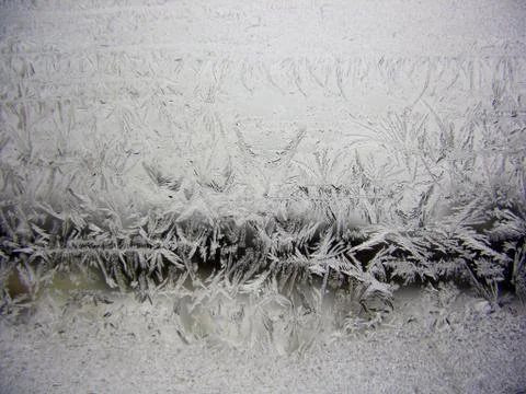 Snow pattern on winter window Stock Photos