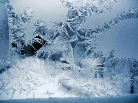 Snow pattern on winter window Stock Photos