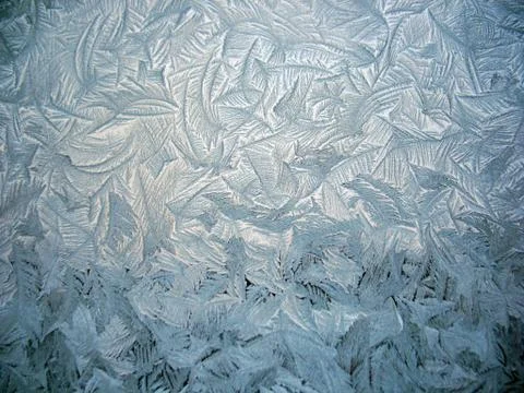 Snow pattern on winter window Stock Photos