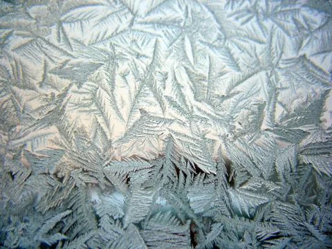 Snow pattern on winter window Stock Photos