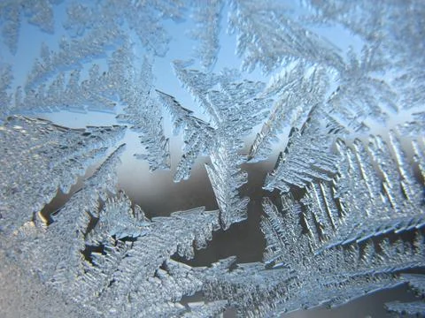 Snow pattern on winter window... Stock Photos
