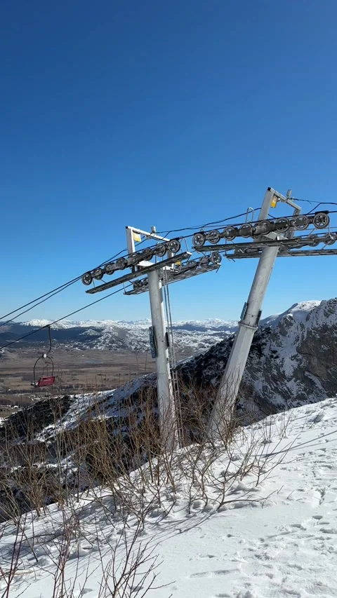 Snow peak. Open empty cabins of the funicular. Bottom plain without snow Stock Footage 265947307