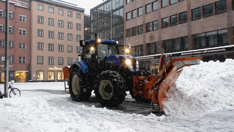 Snow plow clears street in downtown Innsbruck Stock Footage 100975191