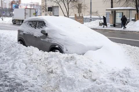 Snow plow left massive drift covering parked SUV completely Stock Photos