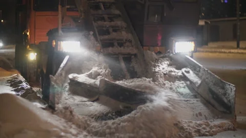 Snow plow machine clearing road in the night Stock Footage 122048596