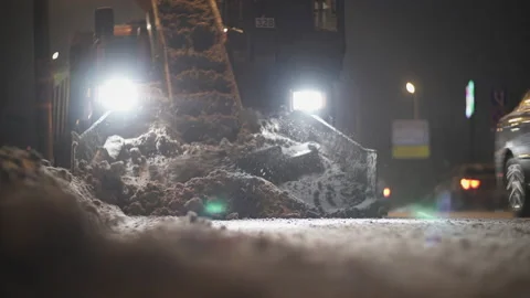 Snow plow machine clearing road in the night. Close Up. Stock Footage 122048793