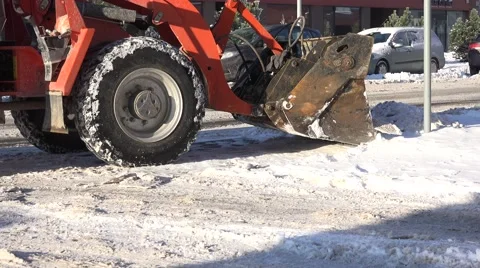 Snow plow machine removing snow from city street after blizzard in winter. 4K Stock Footage 62634080