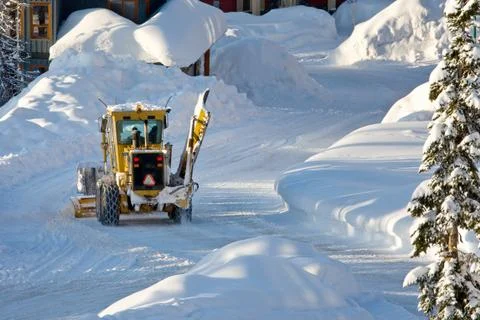 Snow plow working Stock Photos