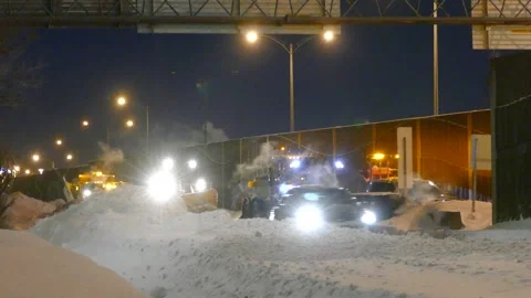 Snow plows clear the road after heavy snowfall in Montreal, Canada. Stock Footage 254011615