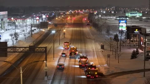 Snow plows clearing Toronto road at night Video stock 345808553