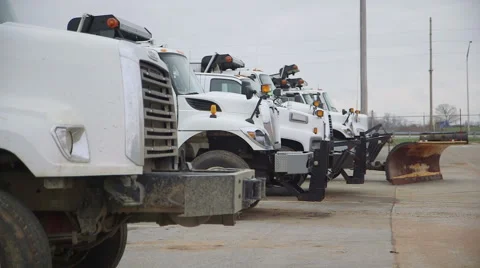 Snow Plows Lined Up in a Parking Lot Stock Footage 58359861