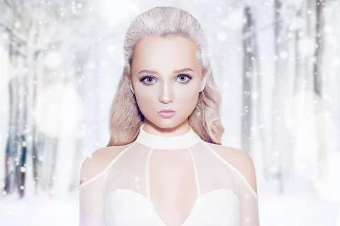 Snow queen on a magic background. Winter woman in a chic white dress, and sno Stock Photos