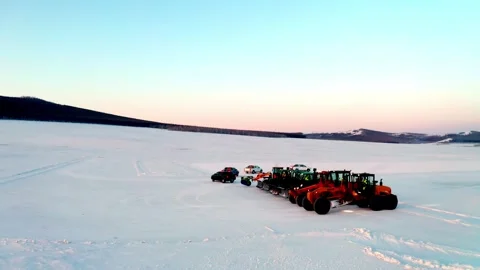 Snow Removal Machinery Lined Up on a Vast Frozen Plain Stock Footage 344951649