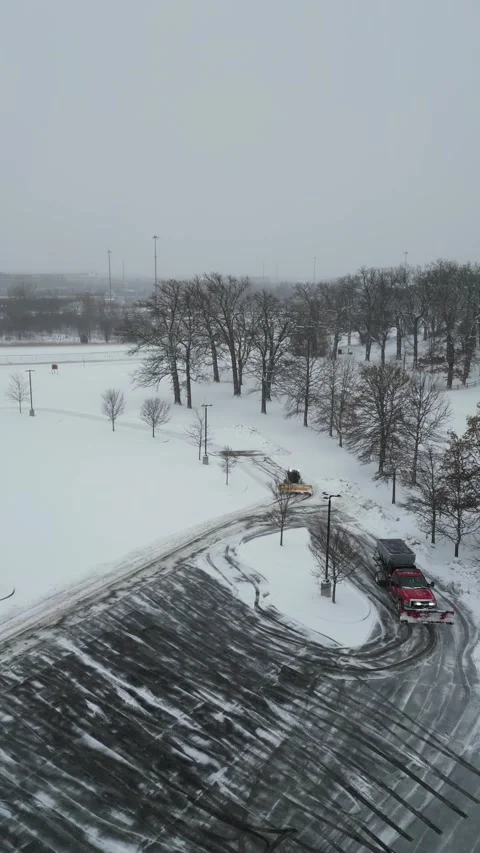 Snow Removal Vehicles Clearing a Large Parking Lot Stock-Footage 332504415