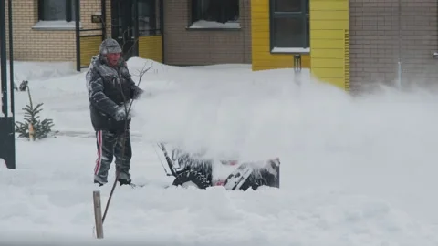 Snow removal work with snowblower after snowfall Stock Footage 228785491