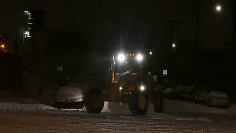 Snow remover during the night Stockbeeldmateriaal 125554750