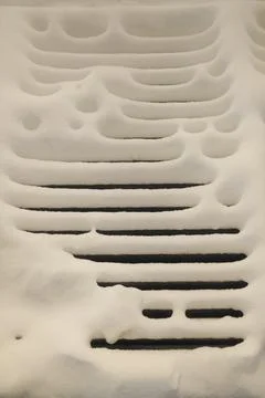 Snow ripples on a dark deck at dawn Stock Photos