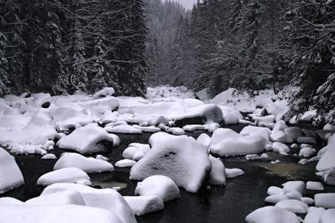Snow on a river Stock Photos
