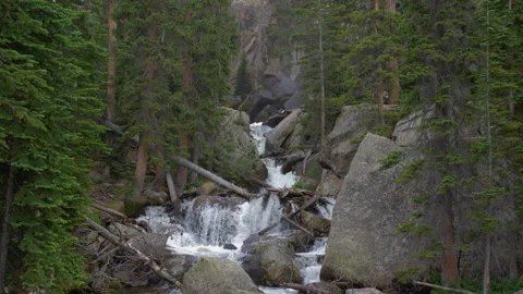 Snow river running through rocky mountain national park 4k 60fps Stock Footage 135495683