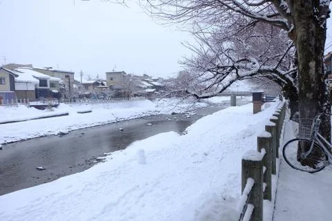 Snow on the river side Stock Photos
