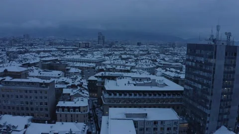 Snow roofs of buildings in the center of Sofia before sunrise Stock Footage 147945585