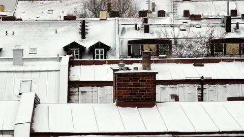 Snow on rooftop with smoke form chimney 1 Stock Footage 87659328